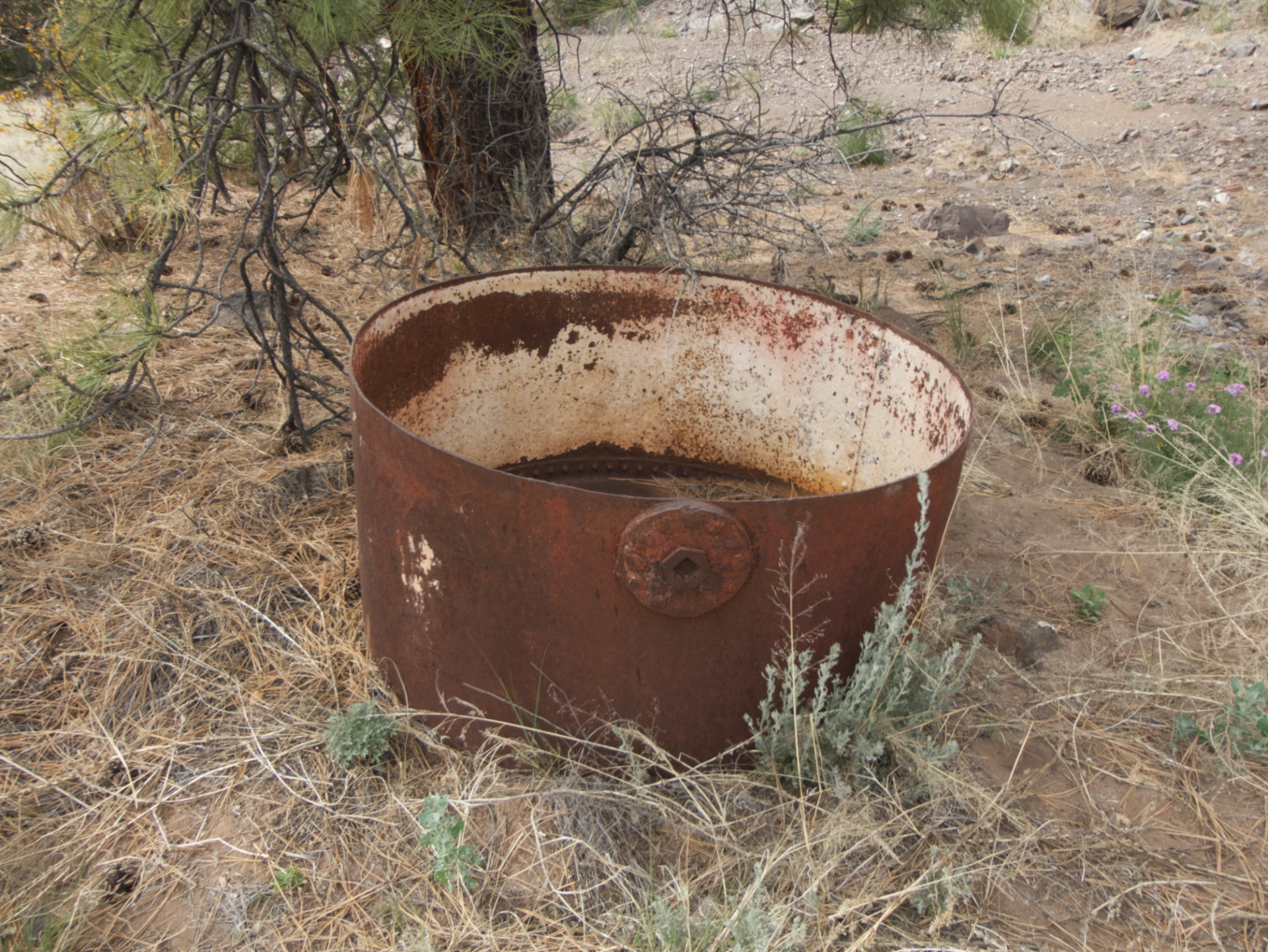 large rusty metal cauldron