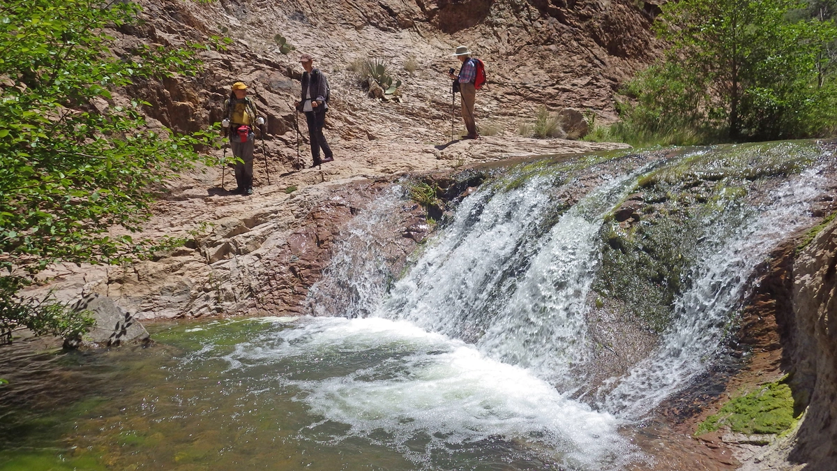hikers by a very sparkly waterfall