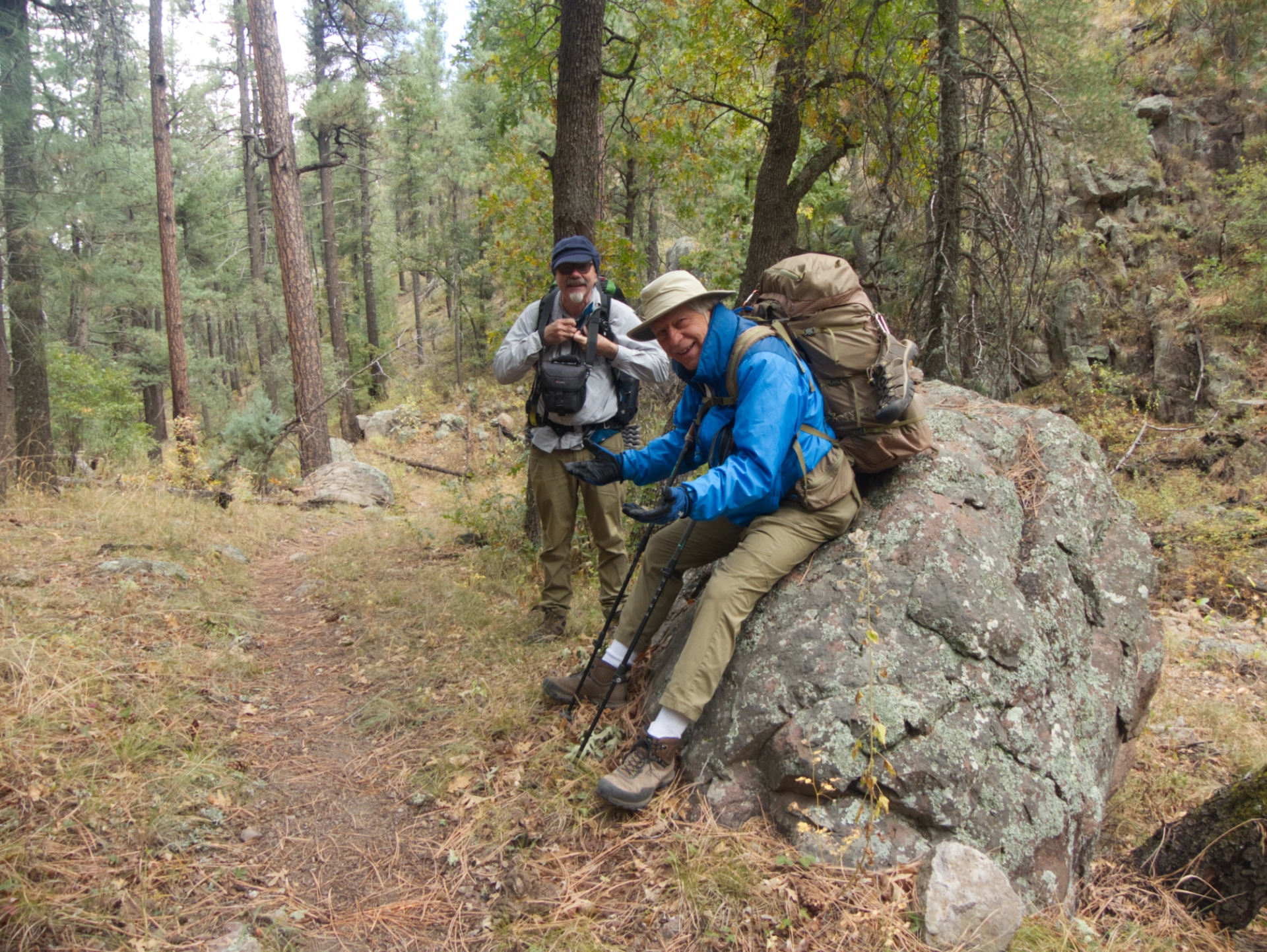 backpackers resting on a rock