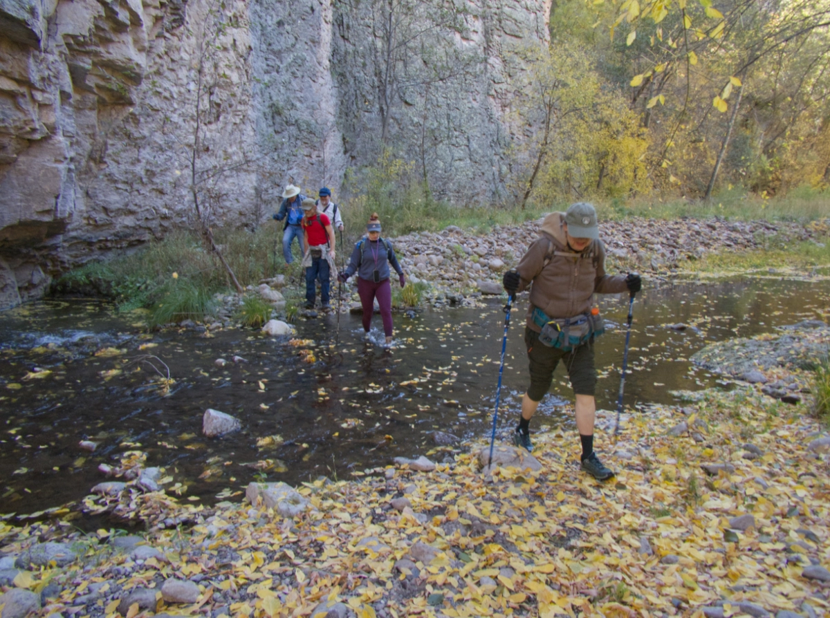 hikers crossing river
