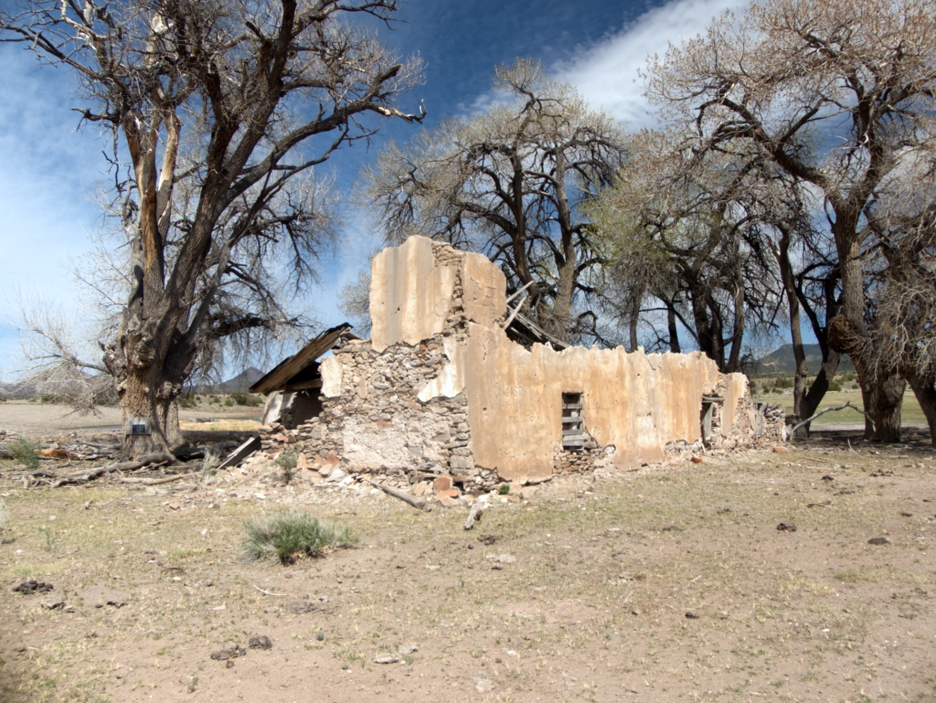crumbling adobe house near a spring