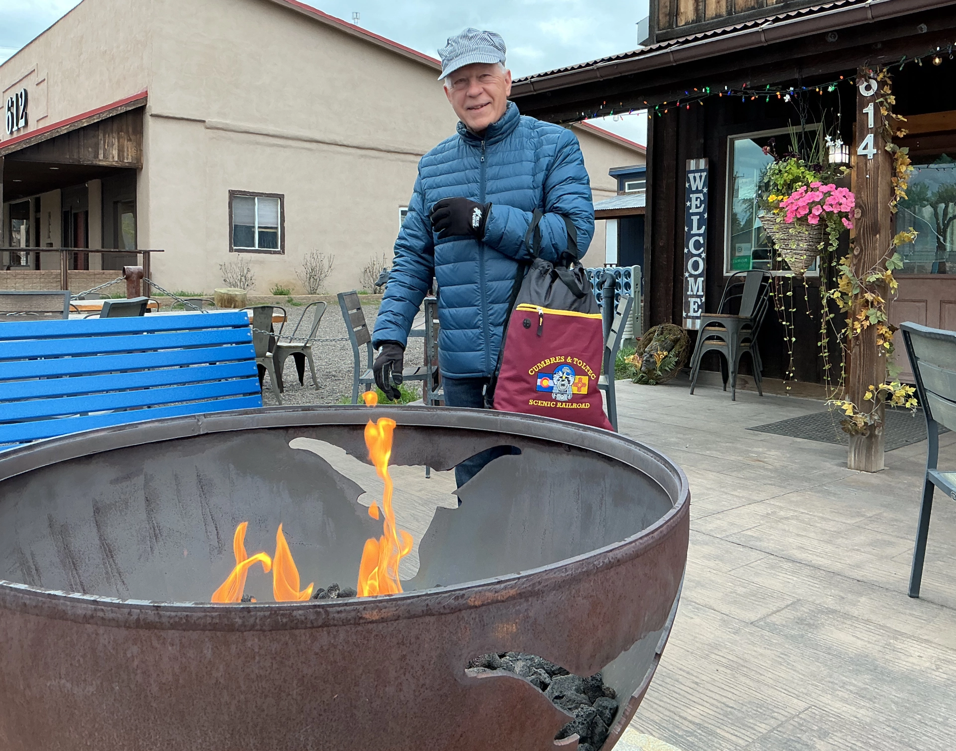 Dennis warming by the fire pit at Rio Chama Espresso