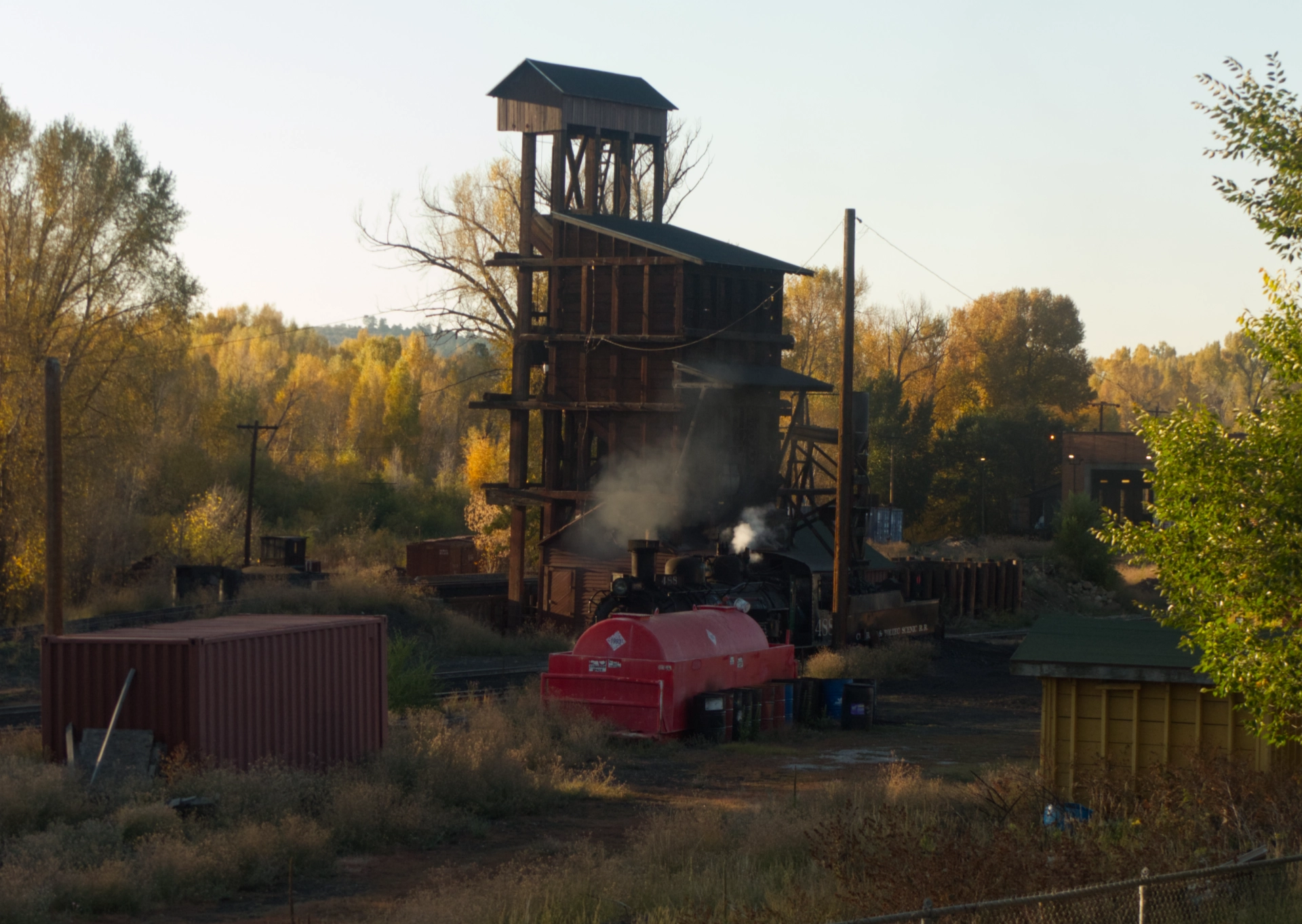 locomotive chuffing steam in the early morning light