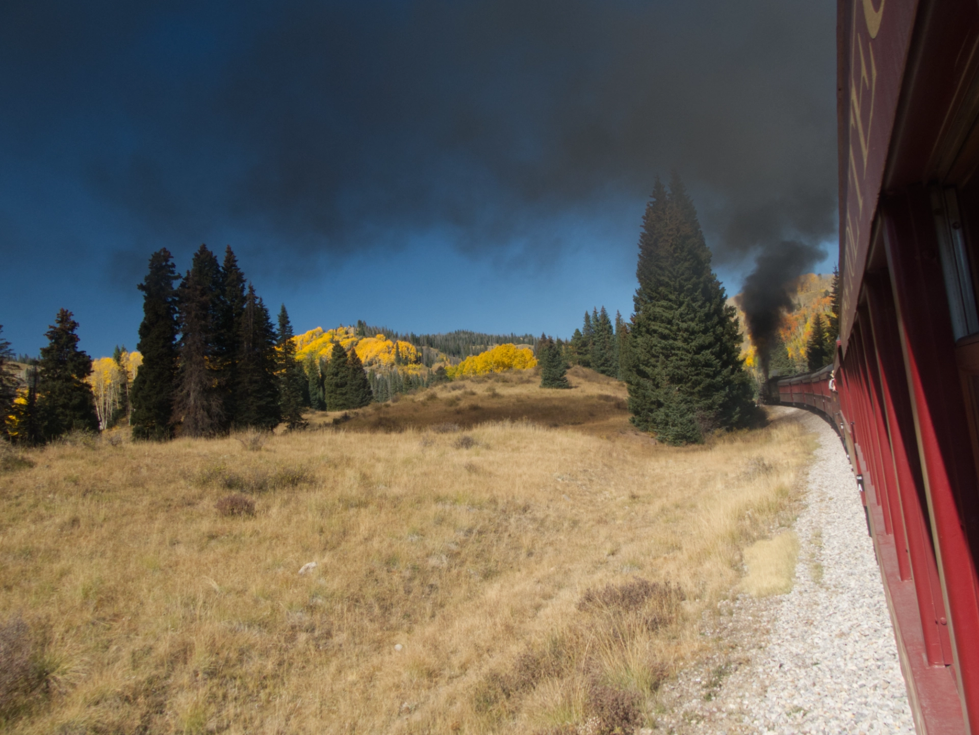 Huge clouds of black smoke as the train rounds a bend