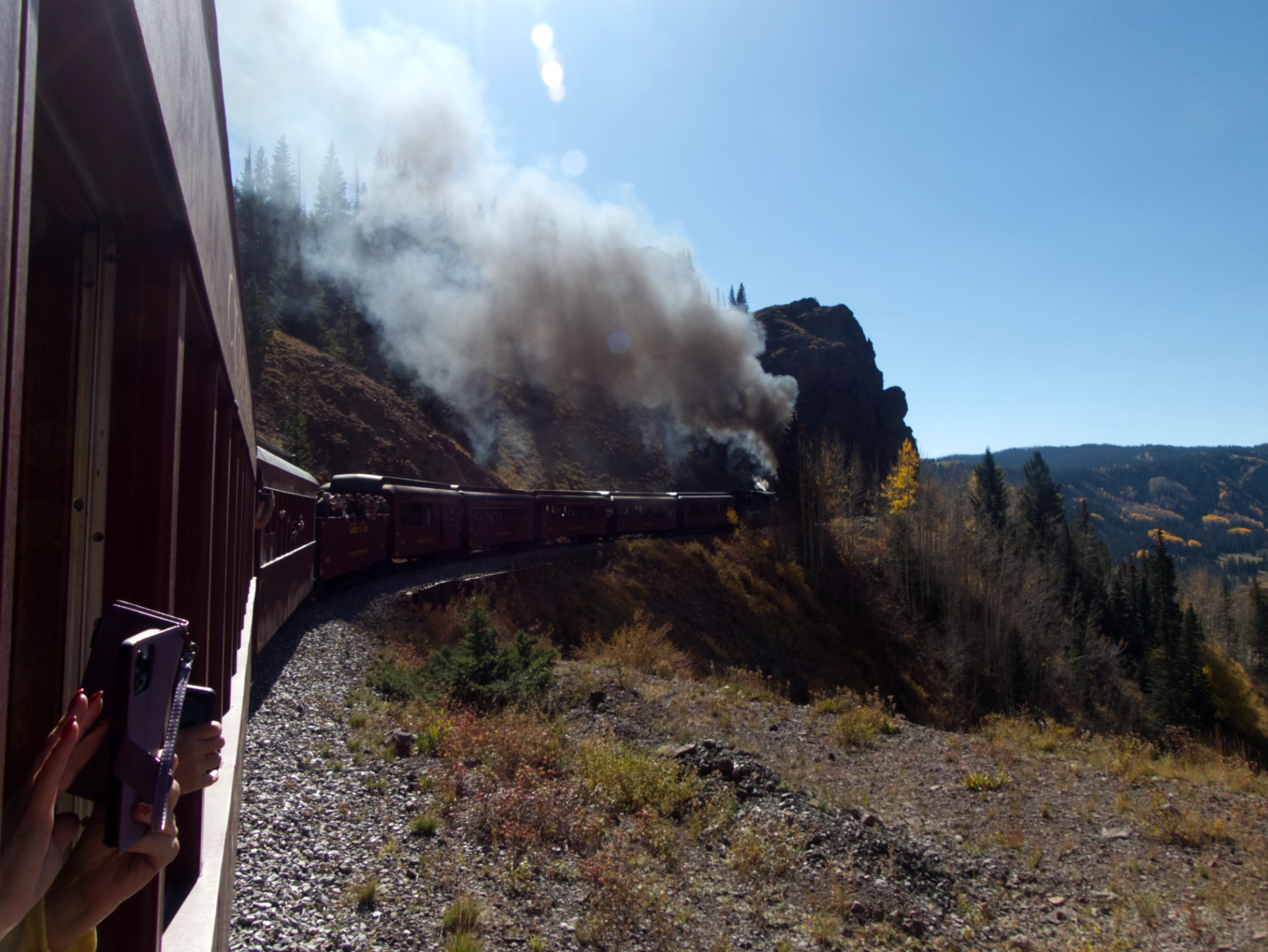 huge clouds of smoke as the train rounds a bend