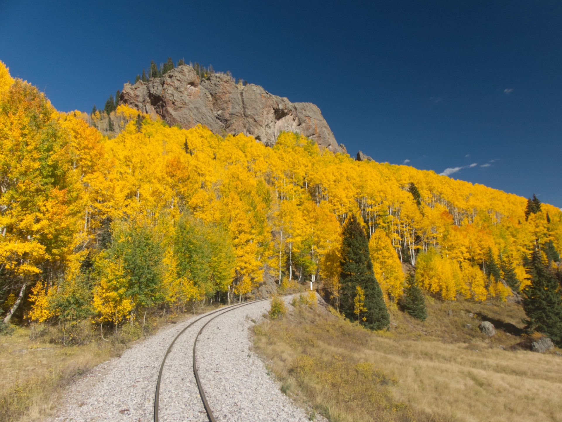 glowing aspens and a rocky prominence