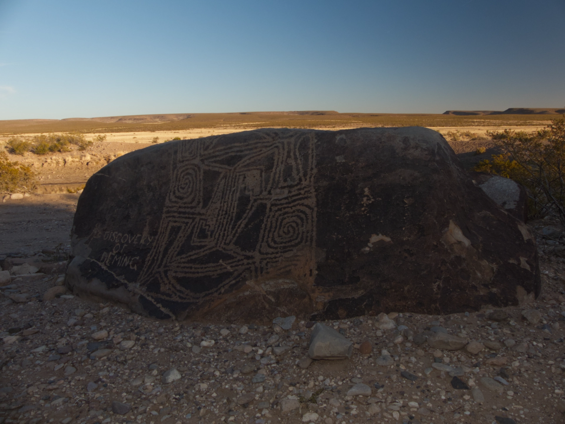 large geometric pattern on a dark boulder