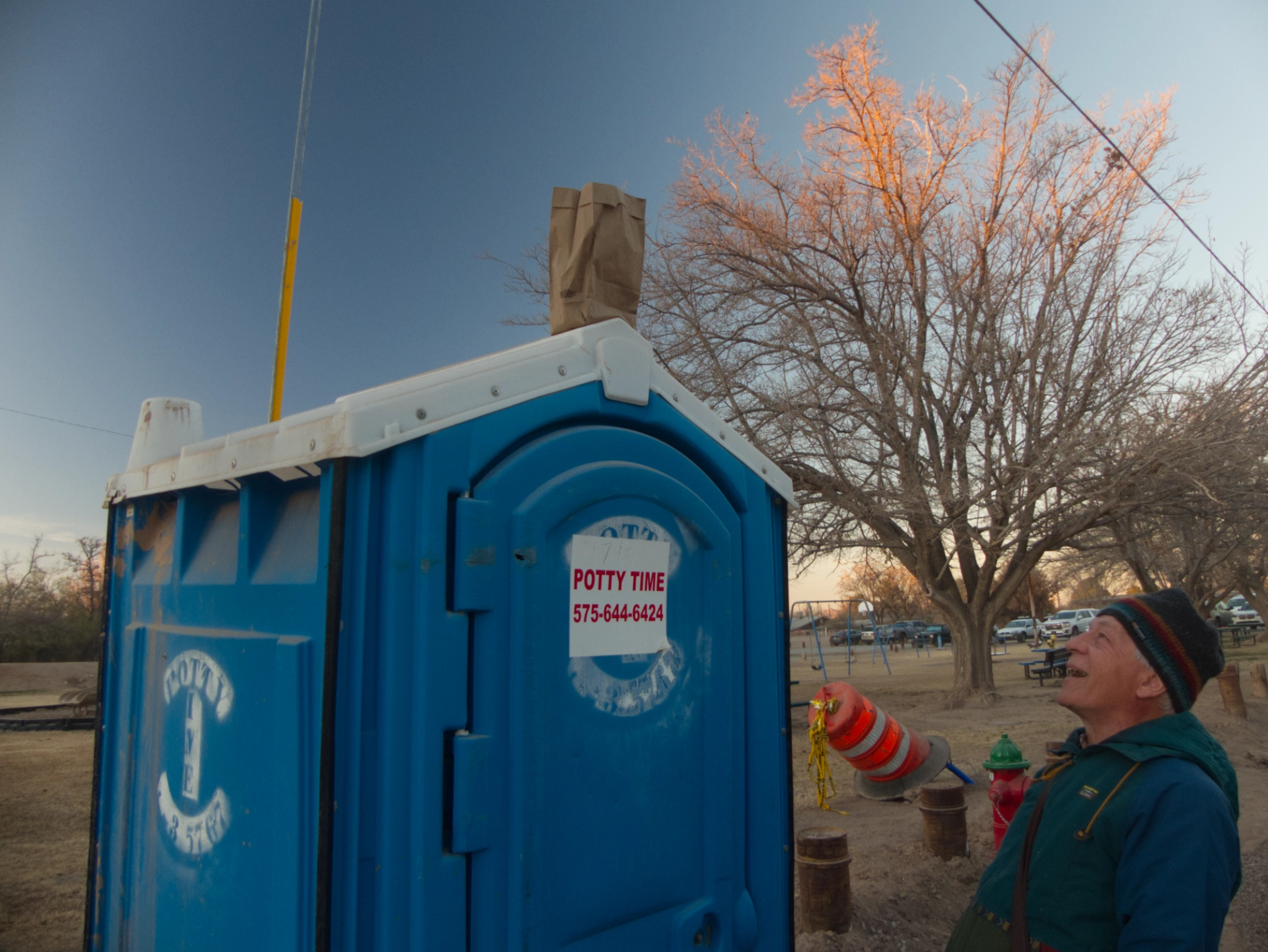 porta potty with a luminaria on the roof