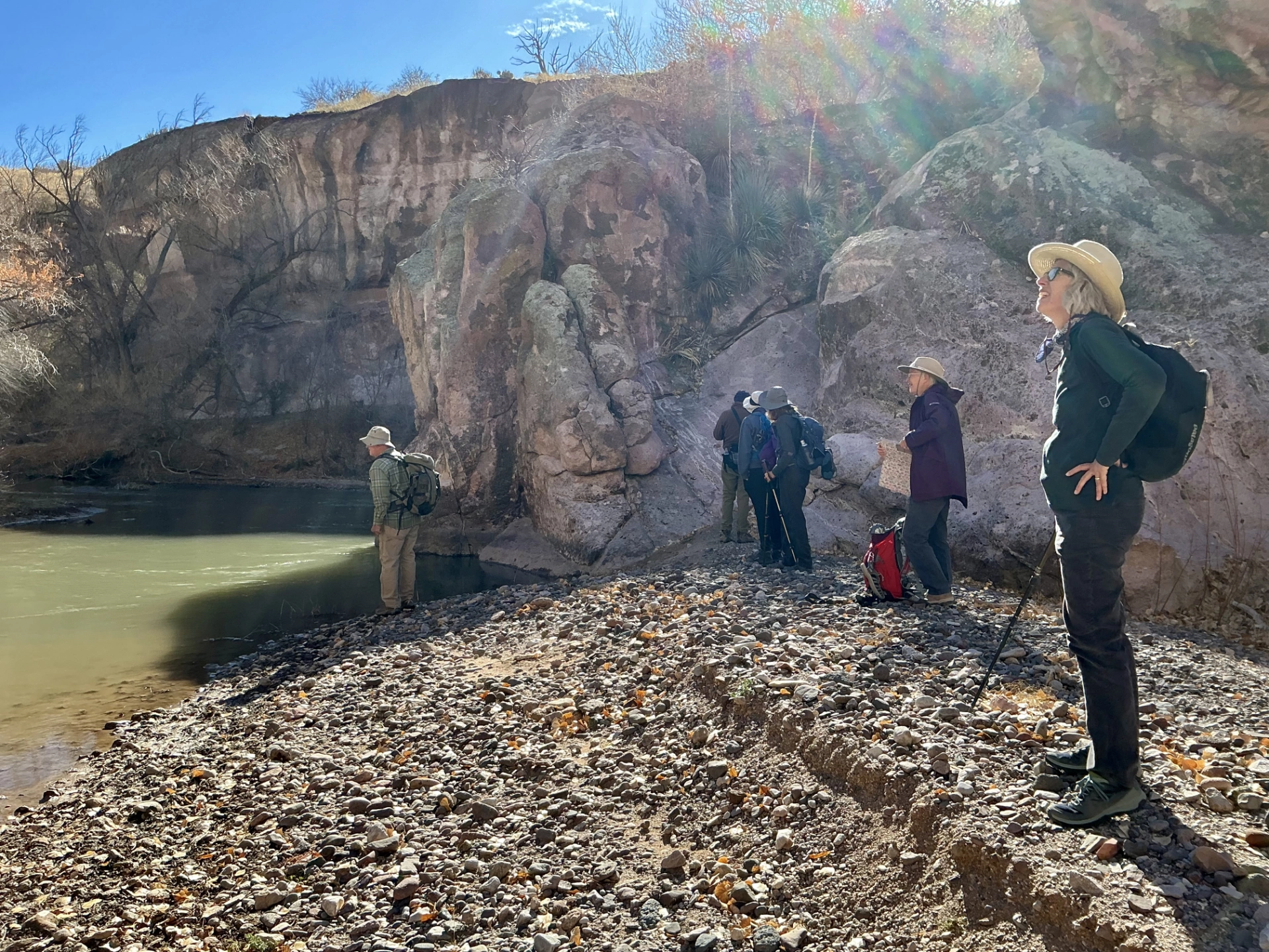 hikers at a bend in the river