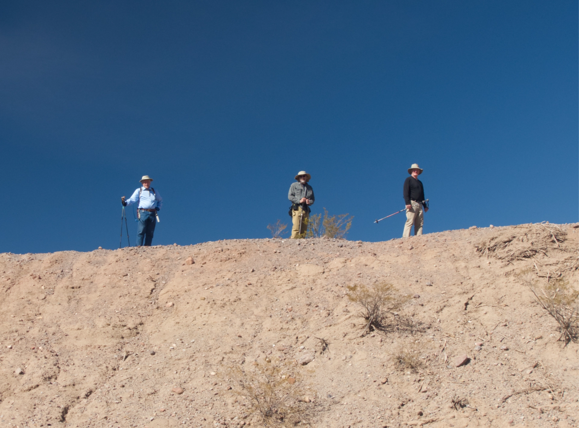 three hikers on a ridge