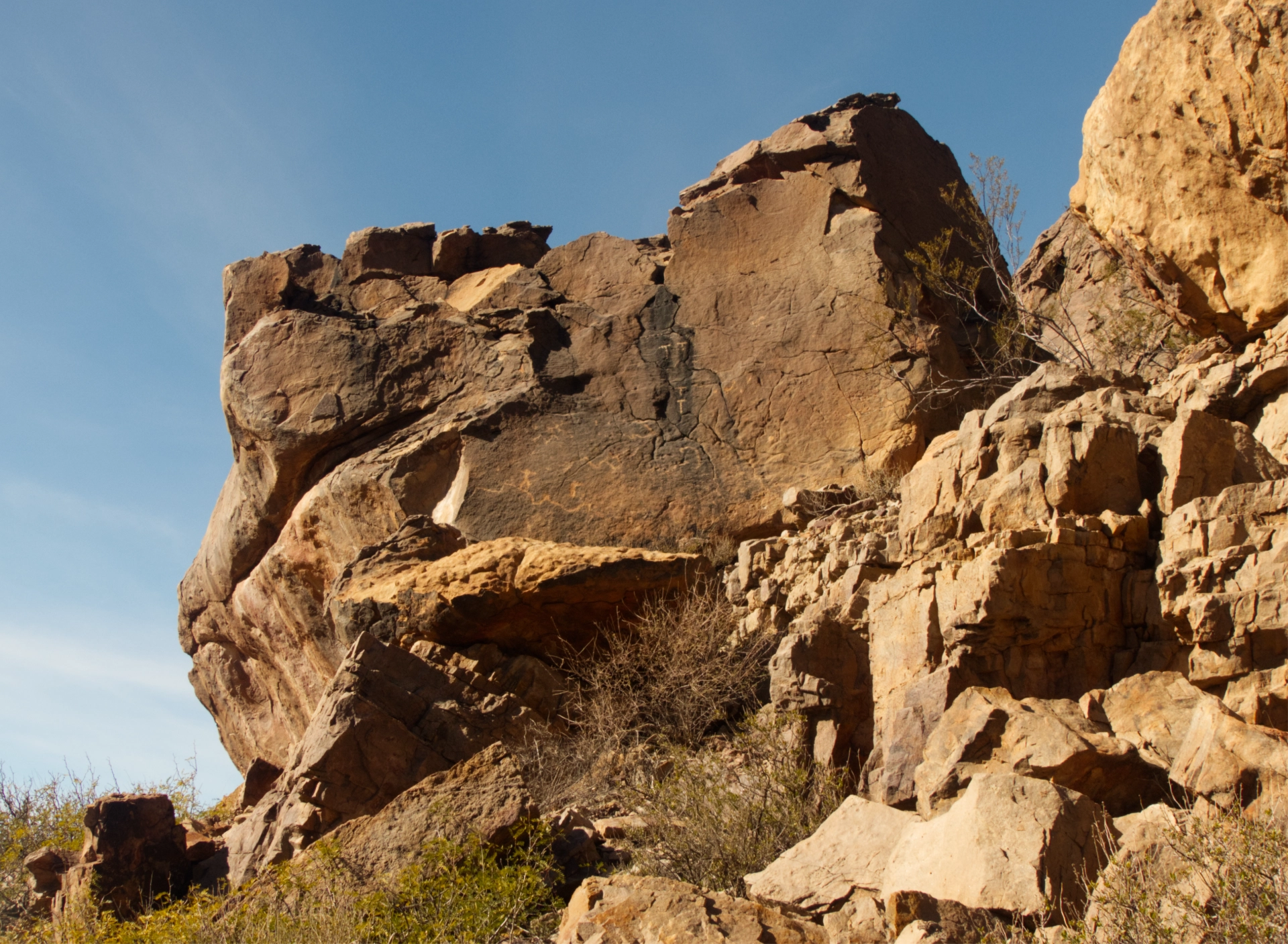 petroglyph panel with hikers on a ridge