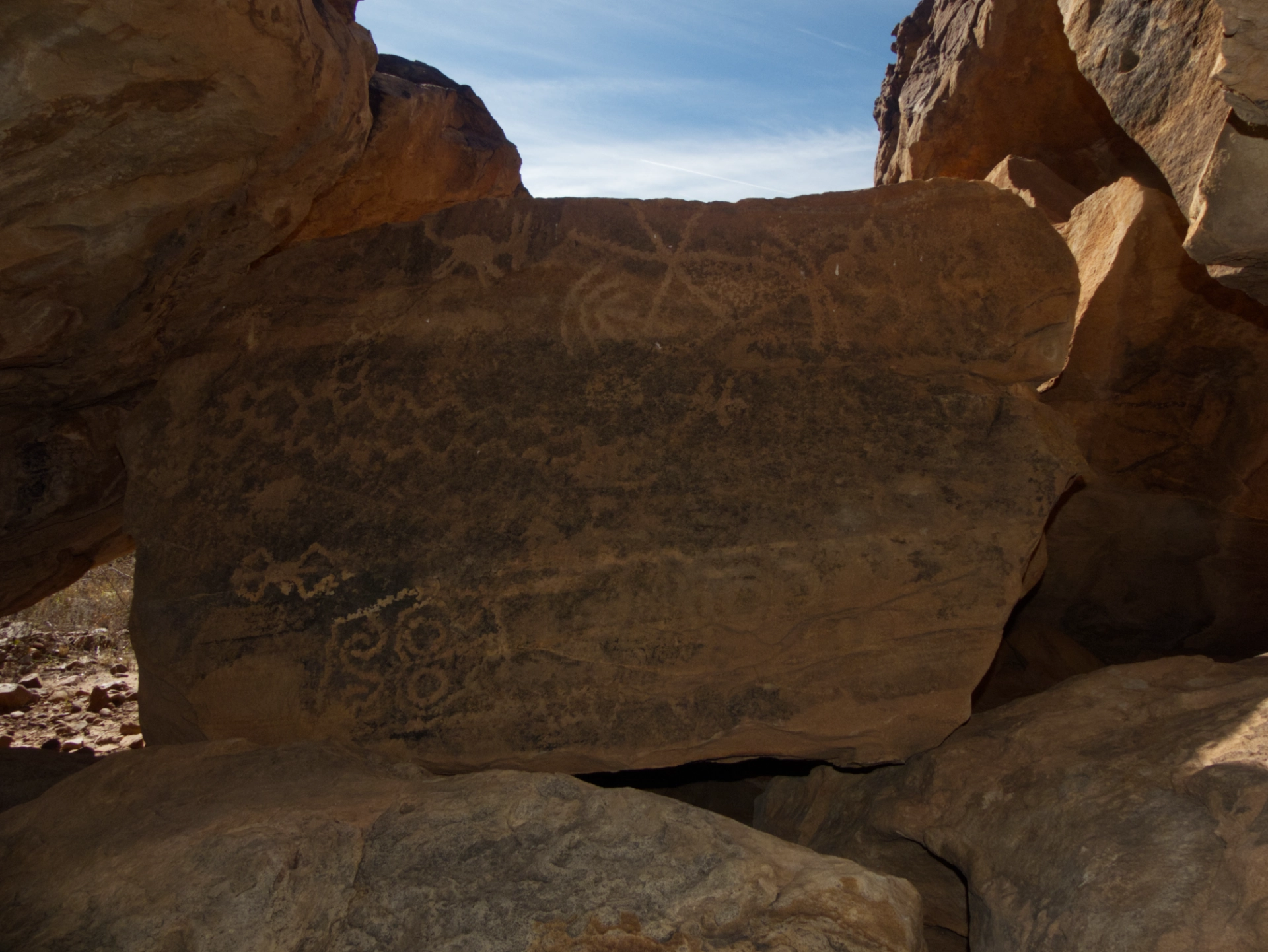 petroglyph panel inside a rock shelter