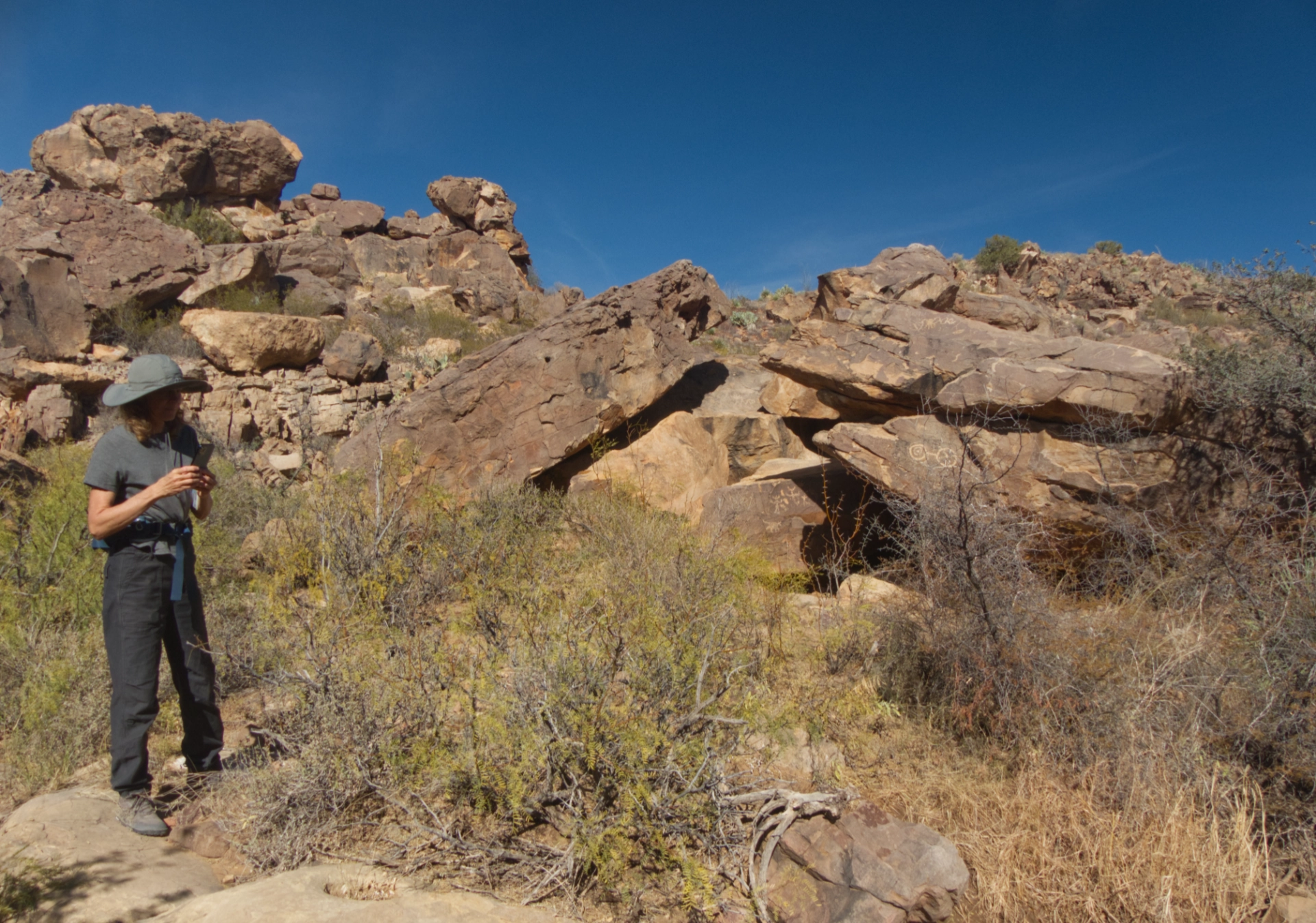 Janett in front of the rock shelter