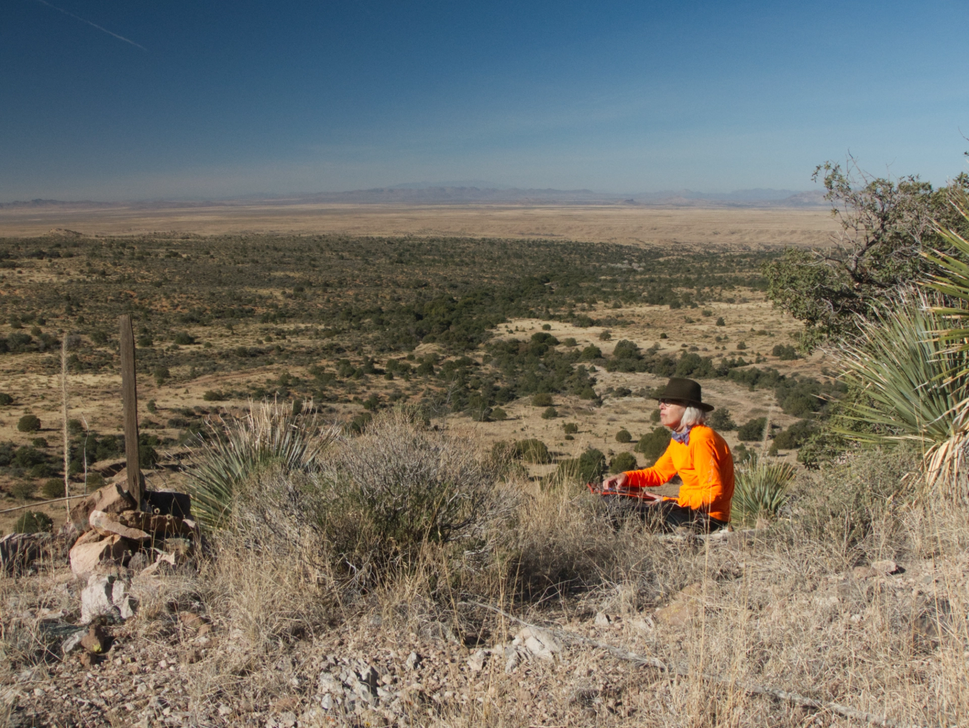 artist sketching on the hillside