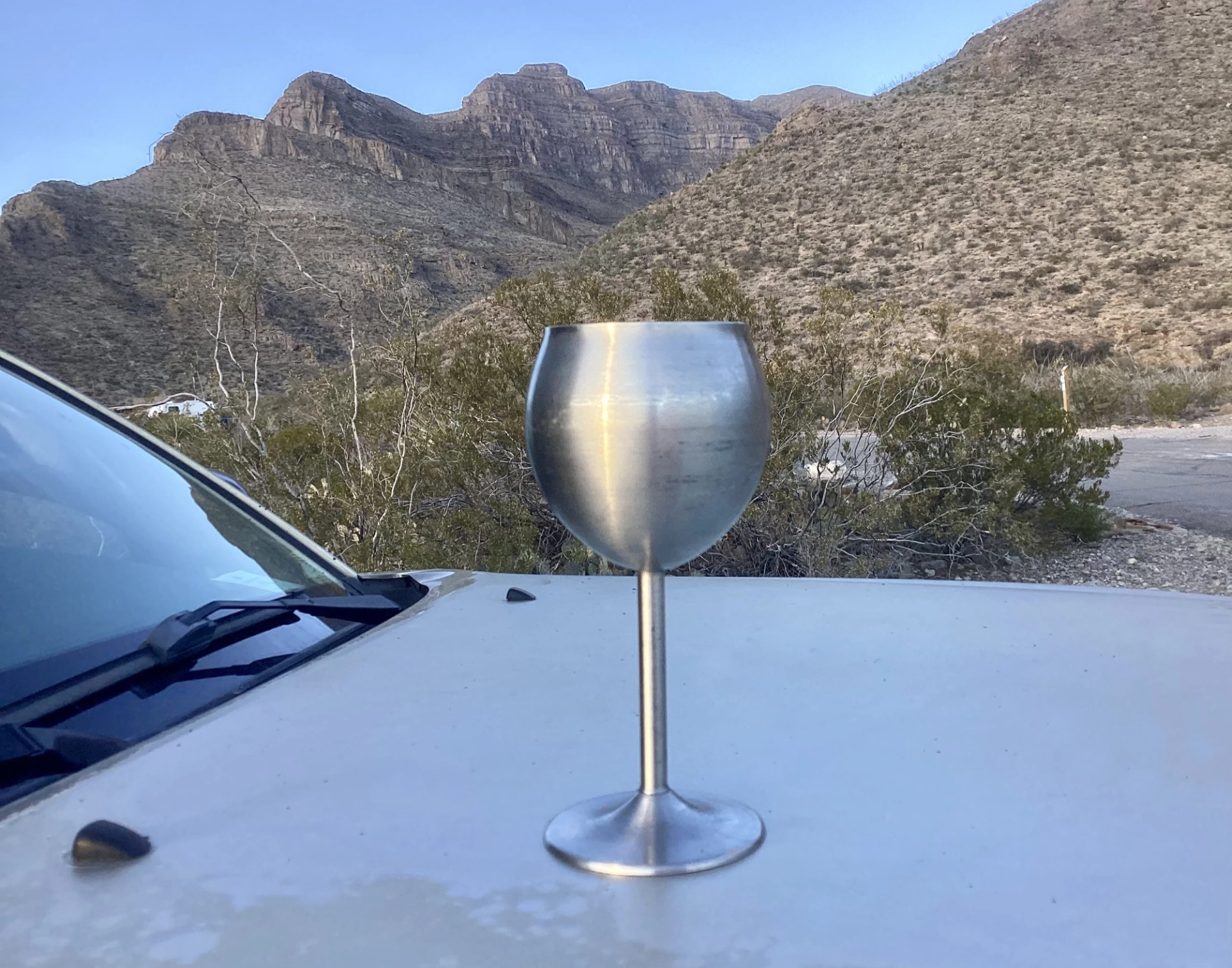a glass of Pinot Noir with a view of Dog Canyon