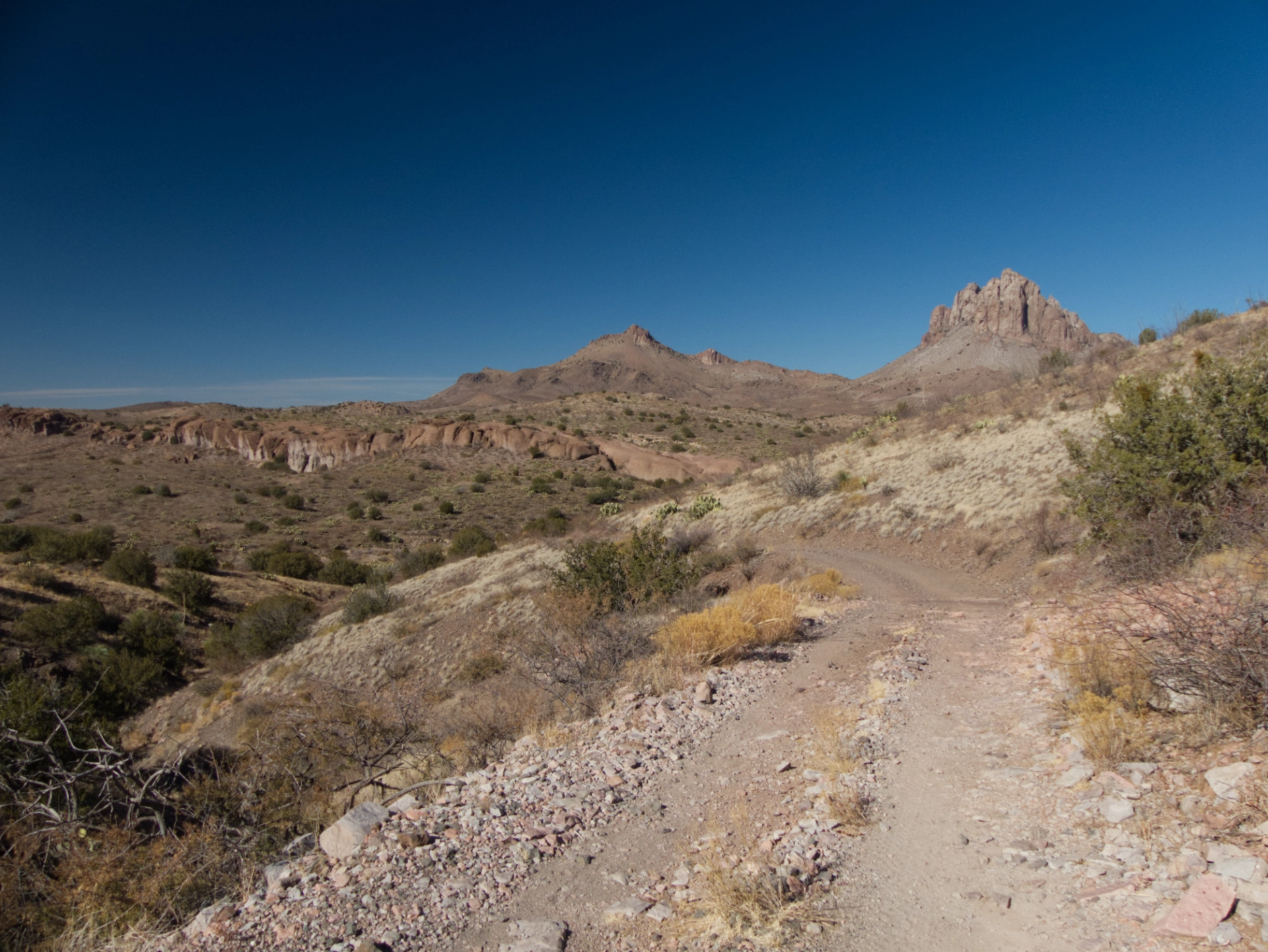 rough road with mountains in the distance