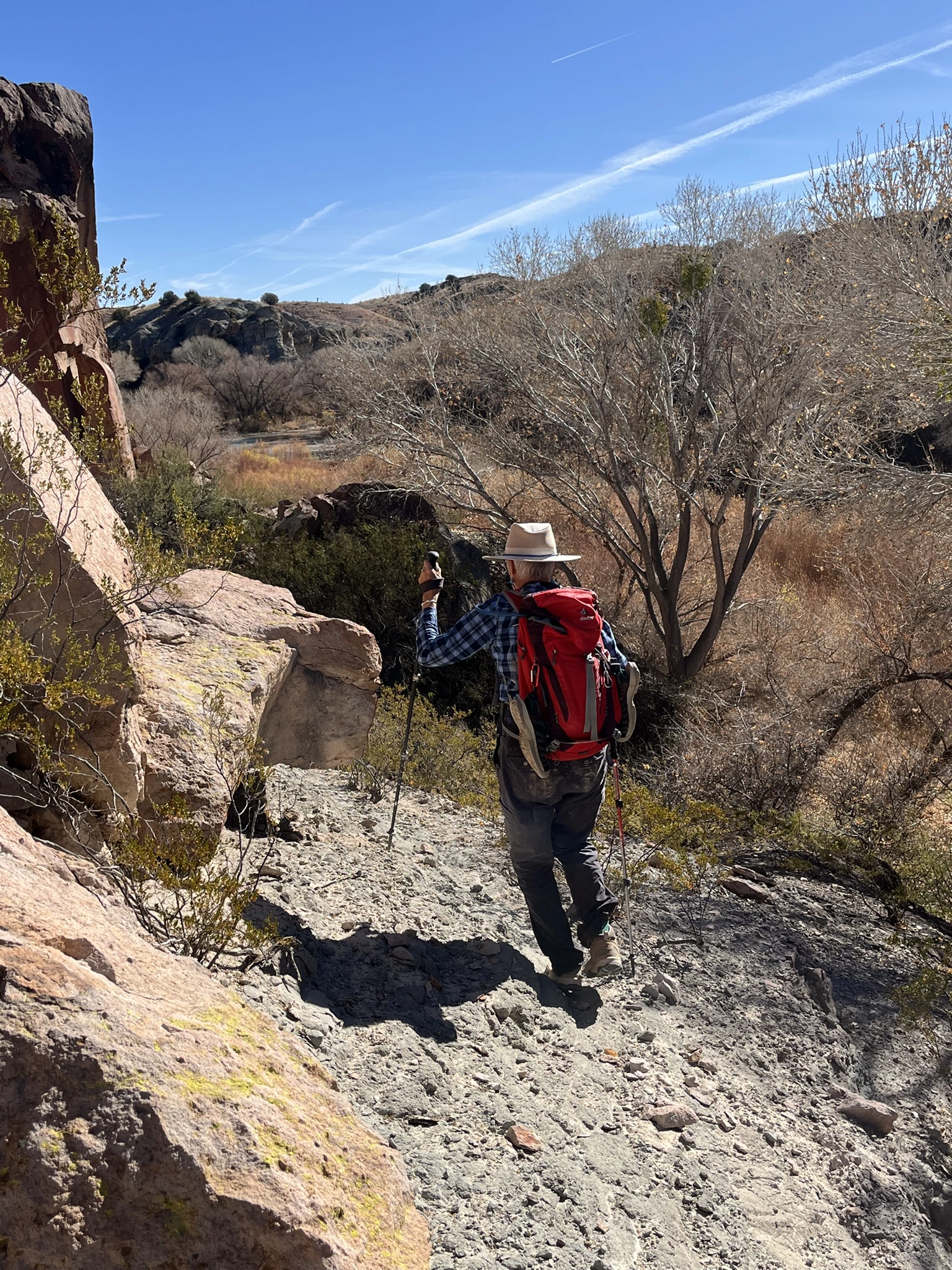 Me hiking along a faint trail high on the cliff