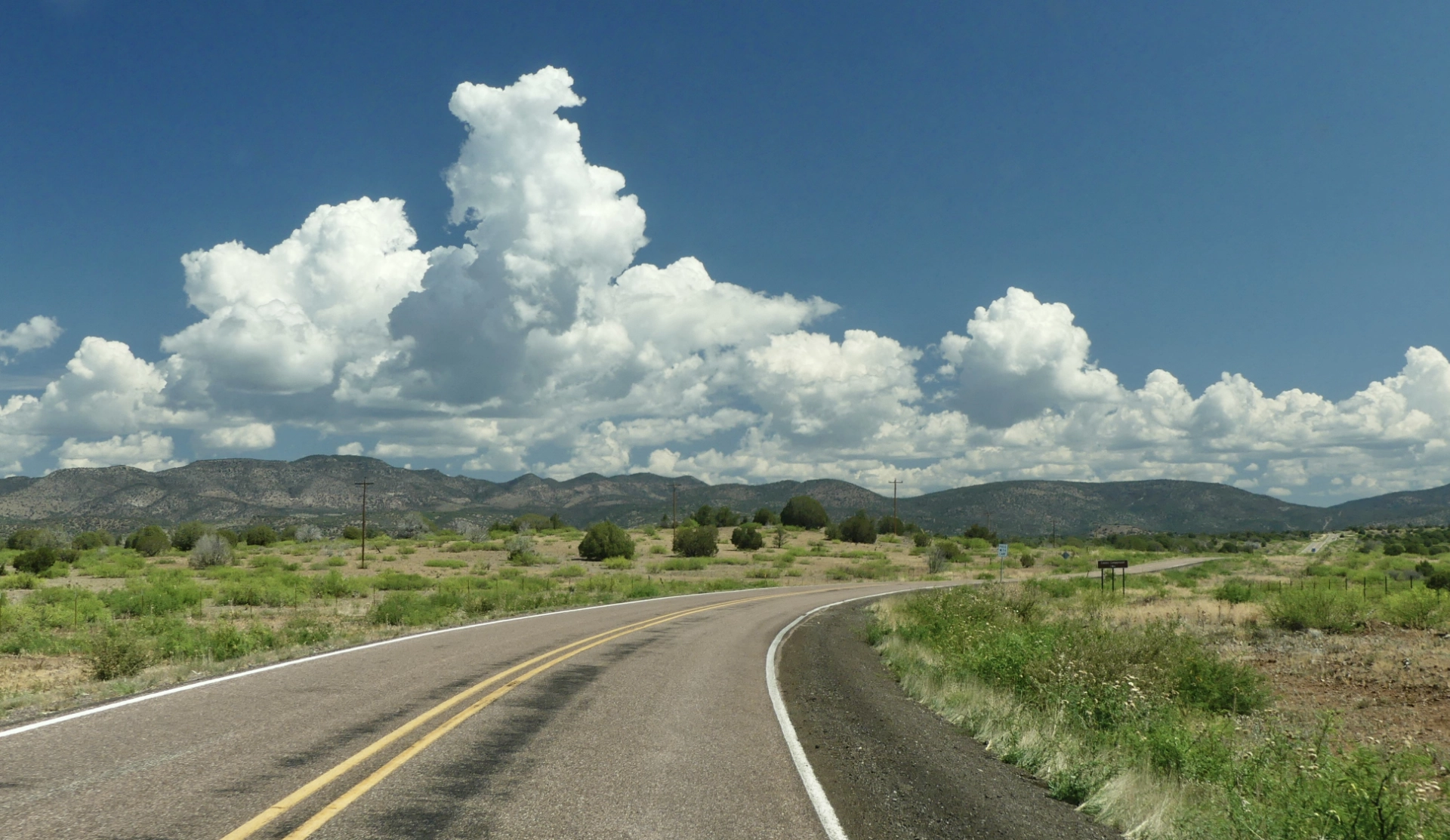 Route 180 with blue sky and puffy clouds